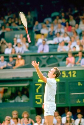 John McEnroe throws his racket